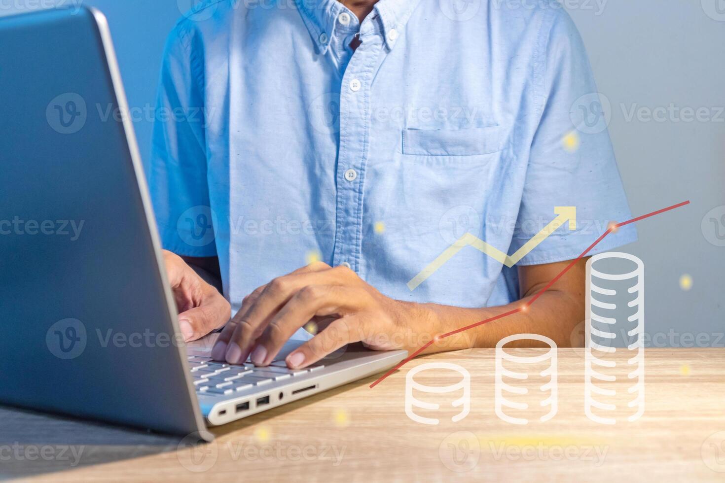 A man using a laptop with virtual screen of business finance data analytics graph chart report photo