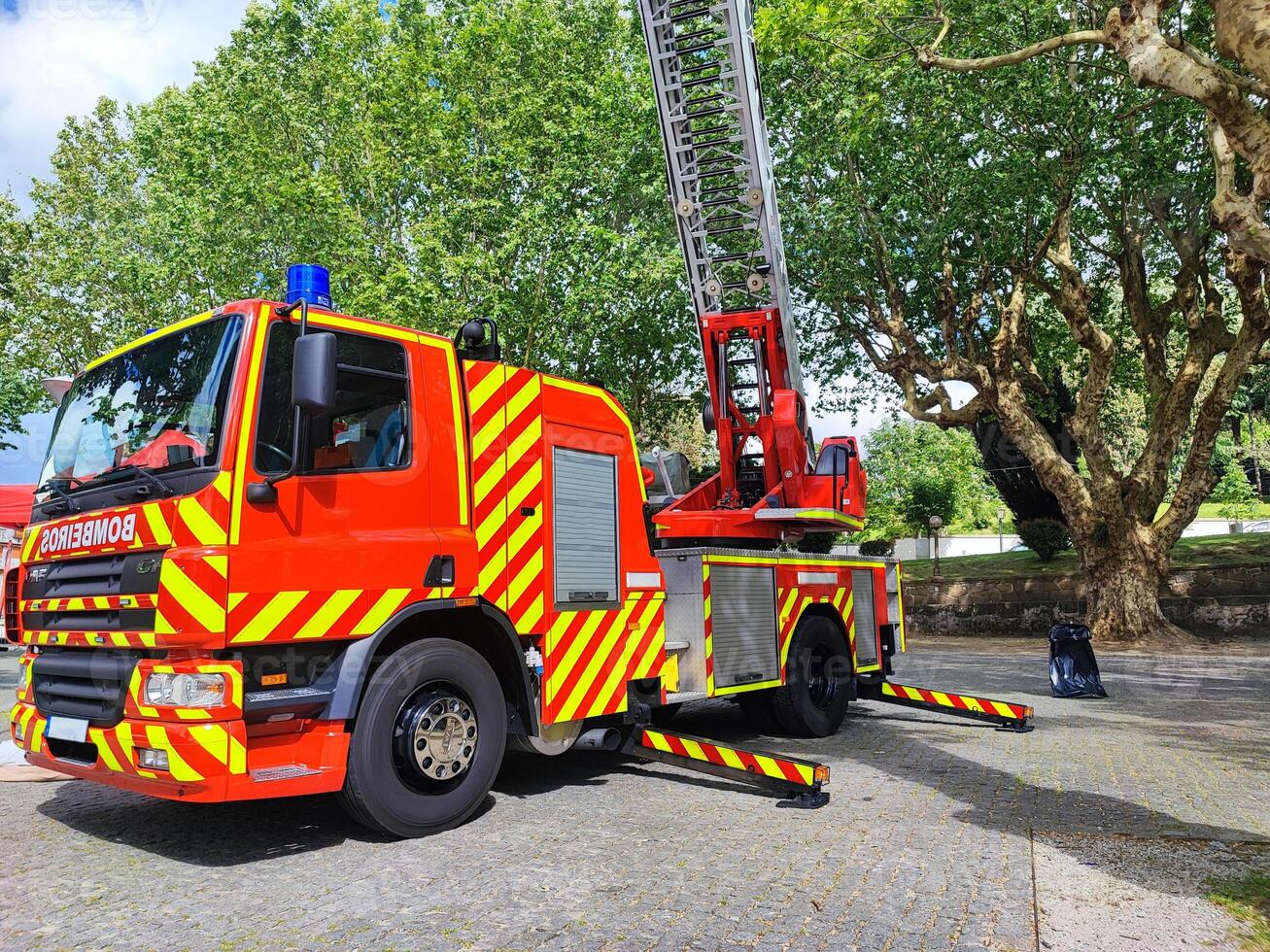 A fire truck stands in full readiness in an open space on a sunny day photo