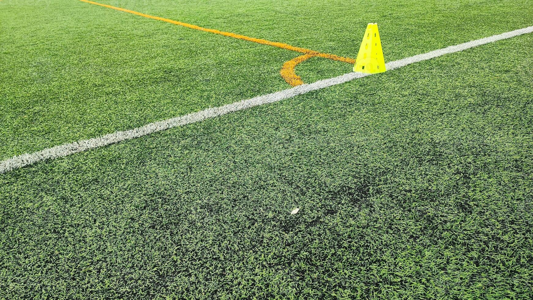 Soccer ball on the green field near the markings. A soccer ball on a green soccer field near the markings photo