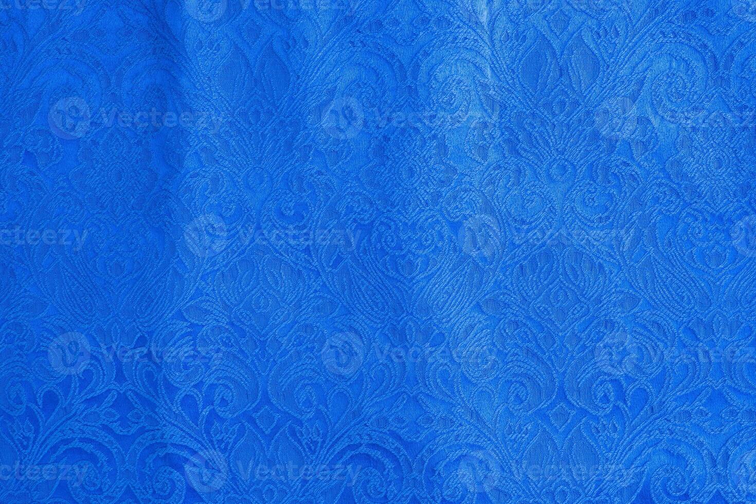 Background is made of blue textile material abstract tapestry drawing, the texture of a piece of clothing. photo