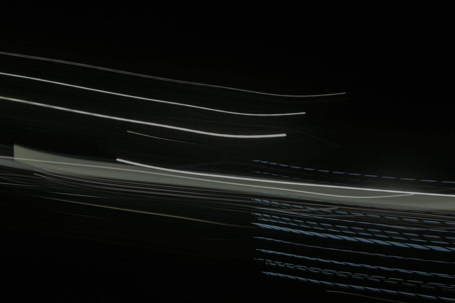 shows a long exposure photograph of light trails in the lamp. The trails are white and green, and they are streaking across the black background photo