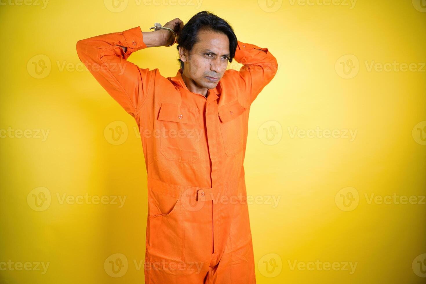Contemplative prisoner man in jumpsuit photo