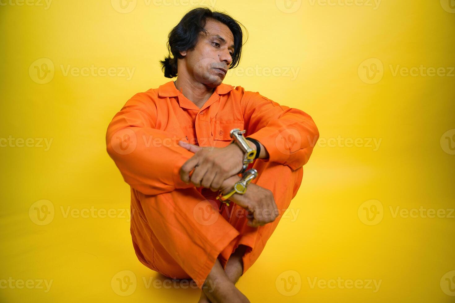 Man Looking down with handcuffs on wrists photo