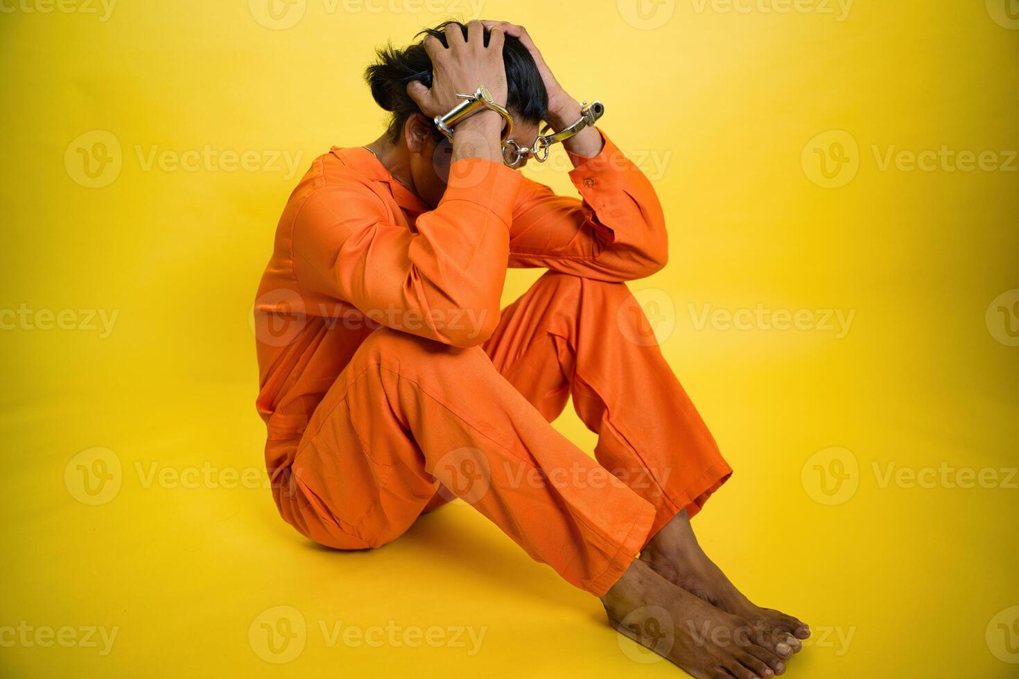 A person in orange prison uniform photo