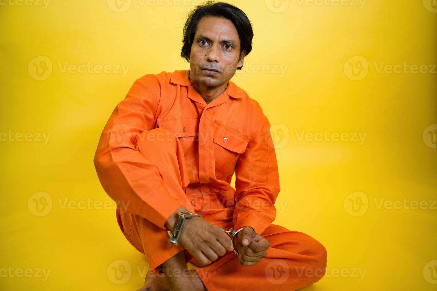 Serious Man in Orange Jumpsuit photo
