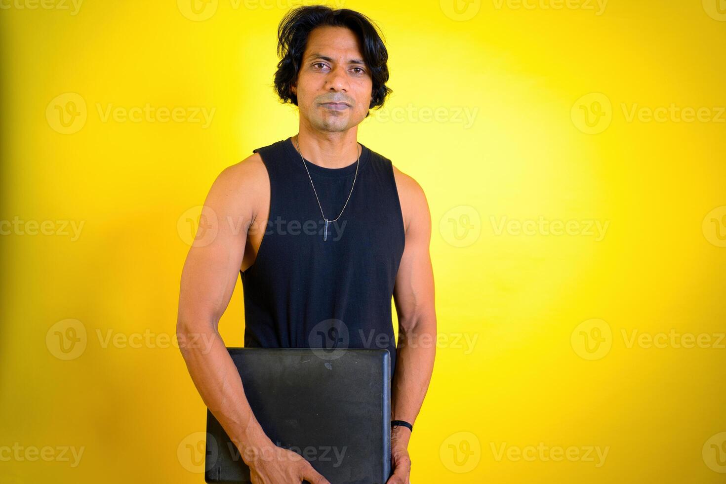 Man holding a closed laptop photo