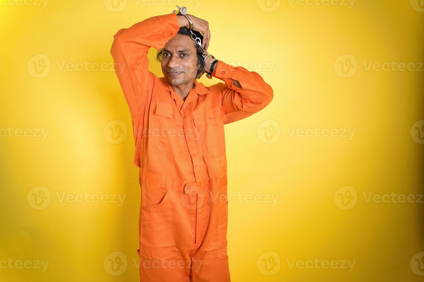 Man in Orange Jumpsuit Handcuffed photo
