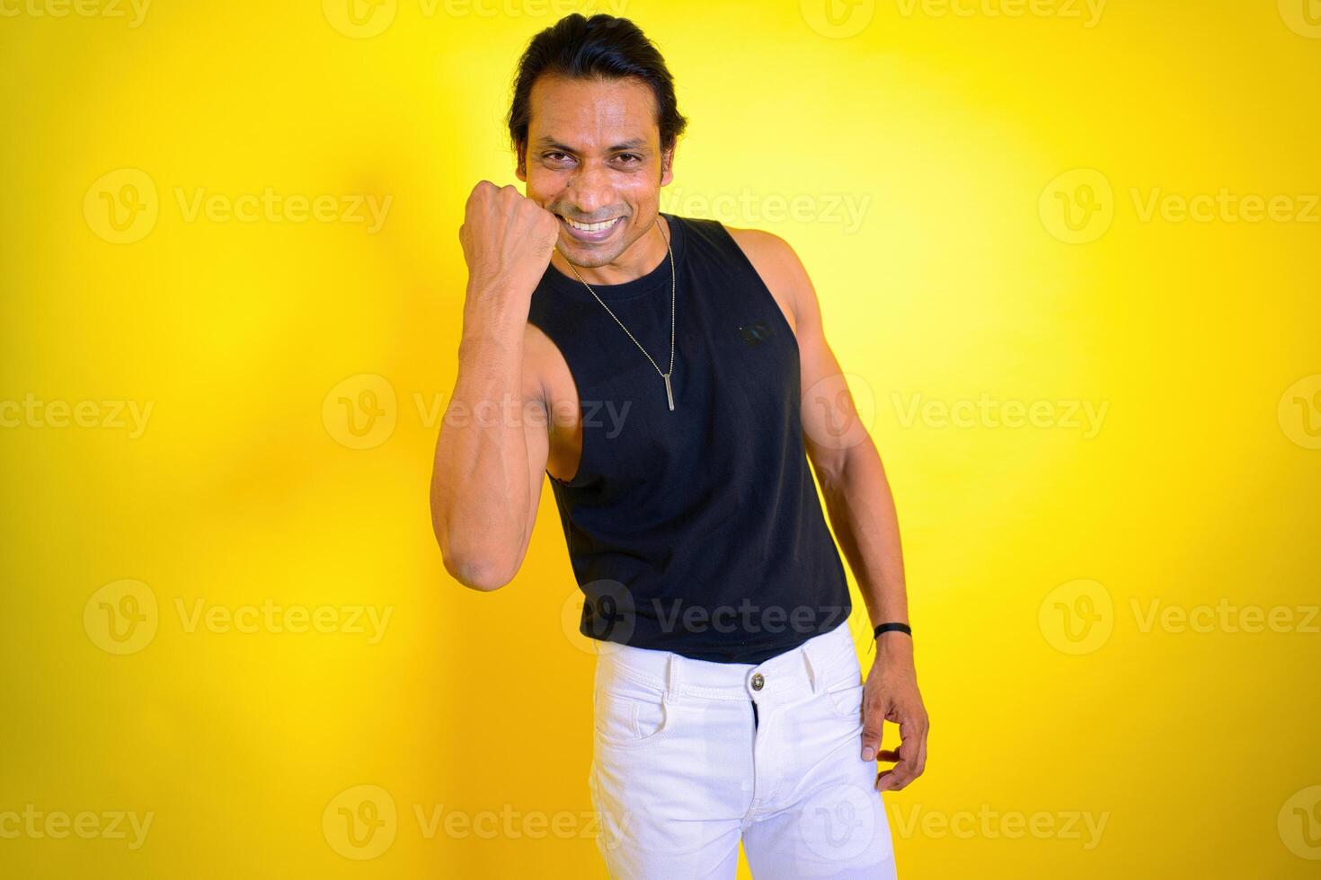 Smiling man posing with a fist photo