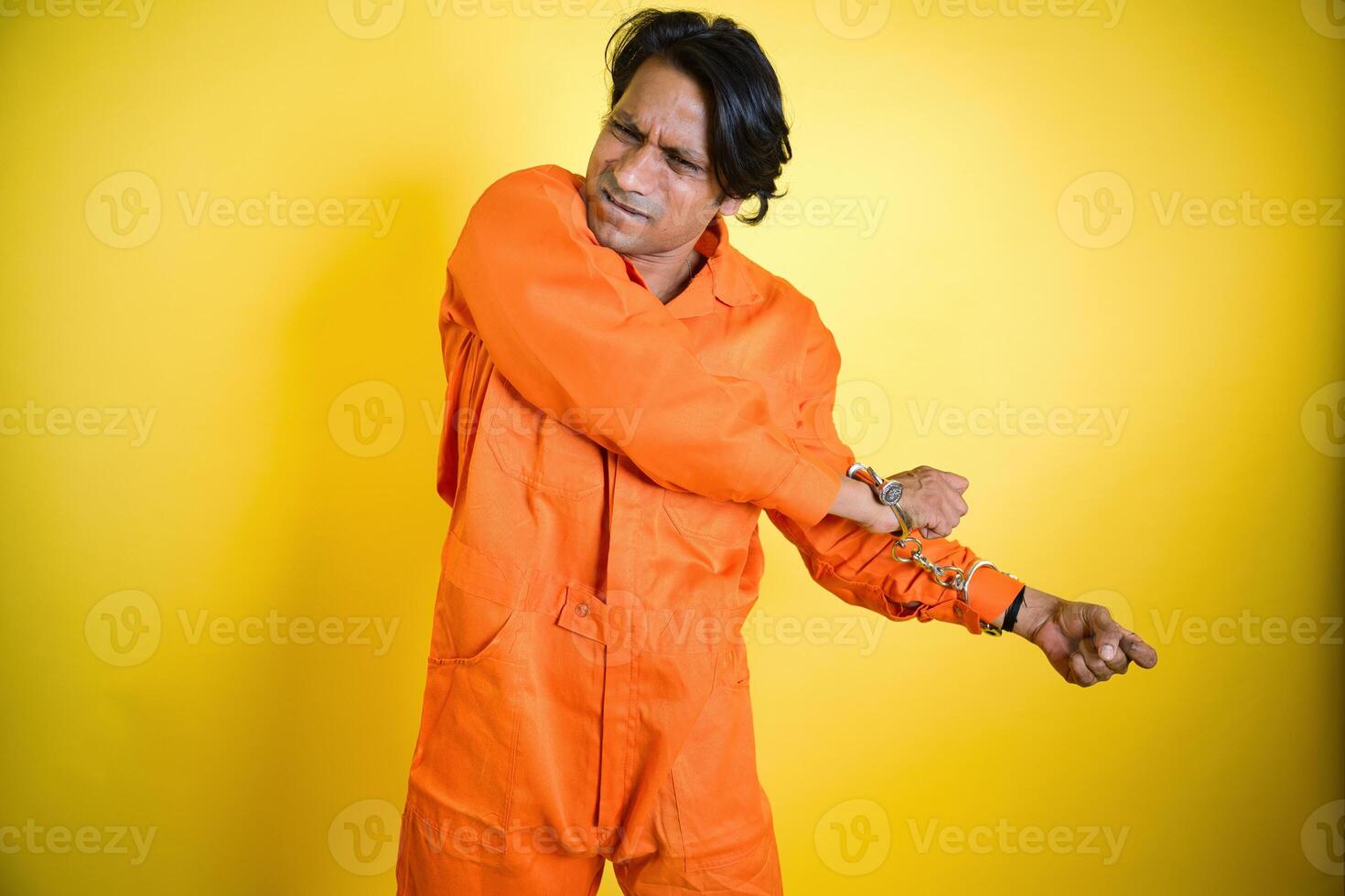 Man pulling hand to break handcuff photo