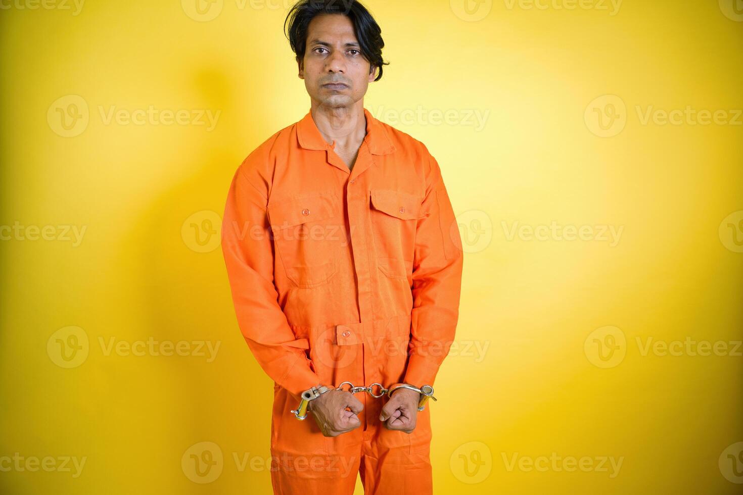 Prisoner stand in orange Jumpsuit photo