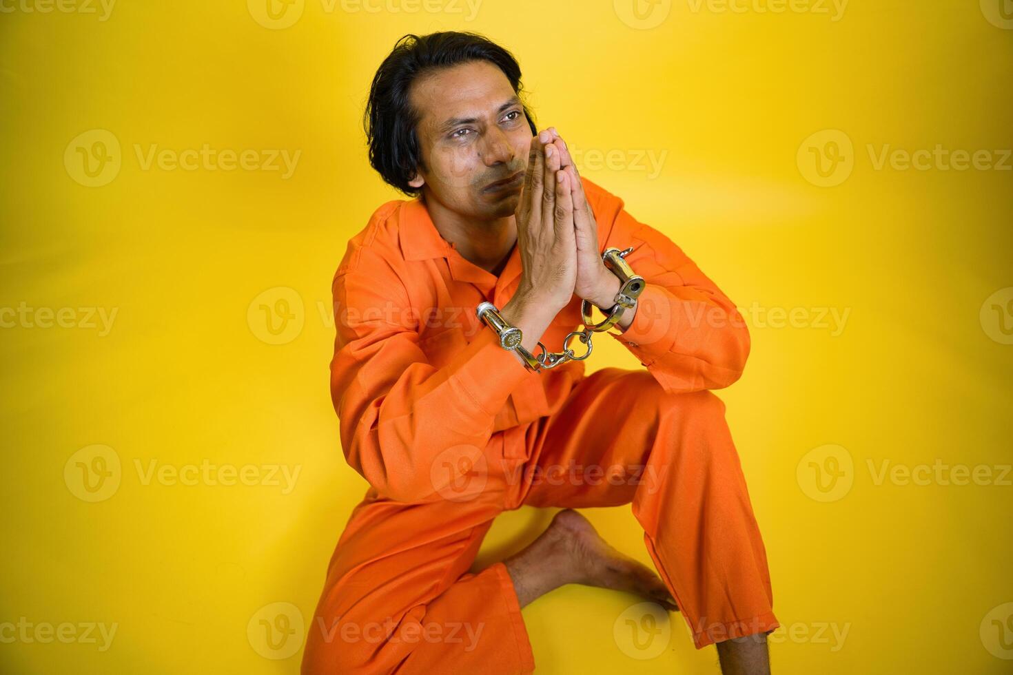 A prisoner apologizing with joining hand photo
