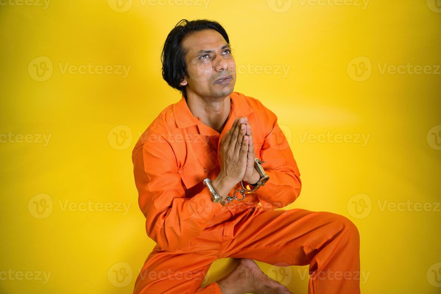 Man sitting in hand join position photo
