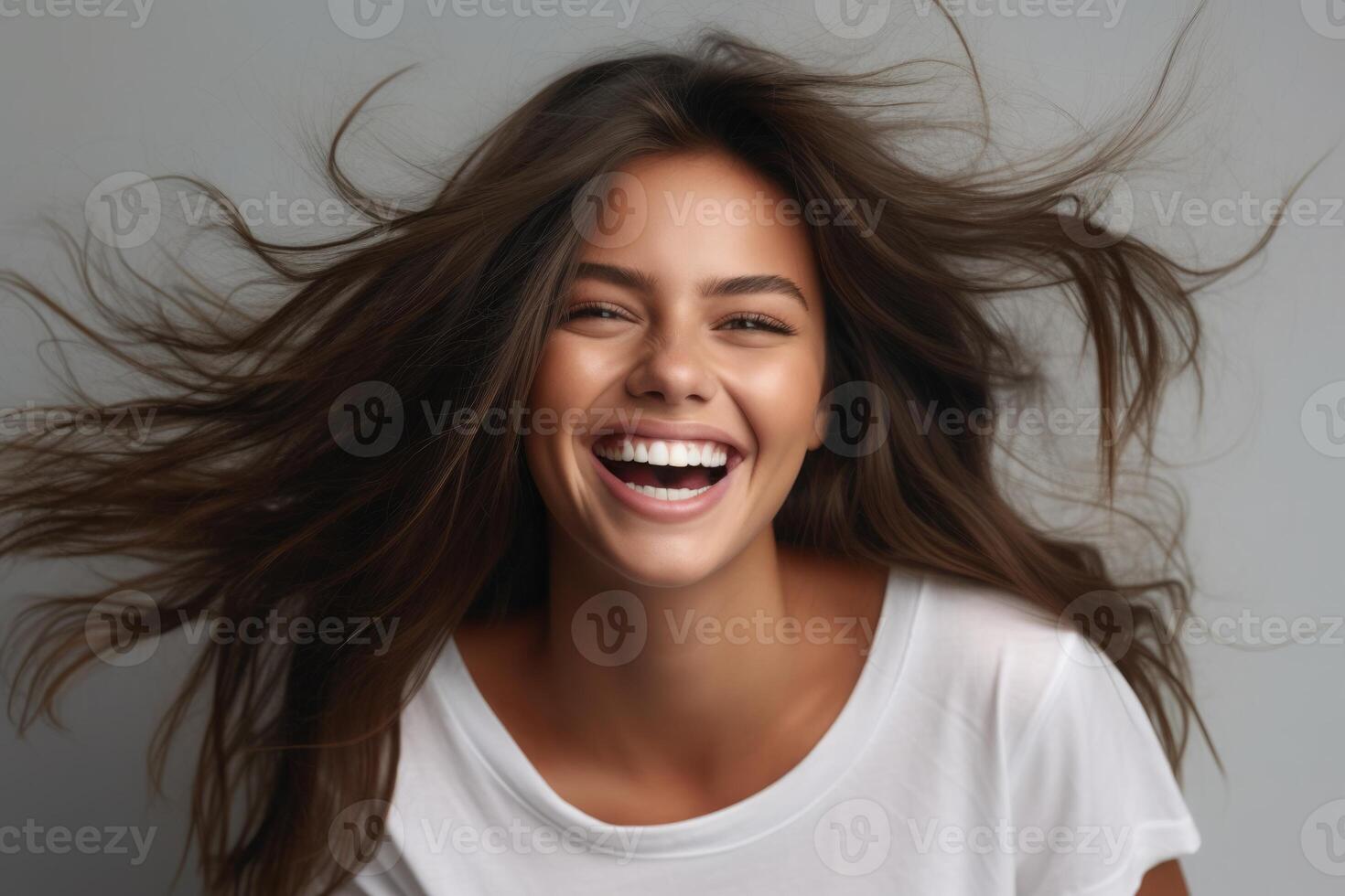 Portrait of young happy brunette with long fuzz hair woman with toothy smile laughing isolated over gray background. Generated AI. photo