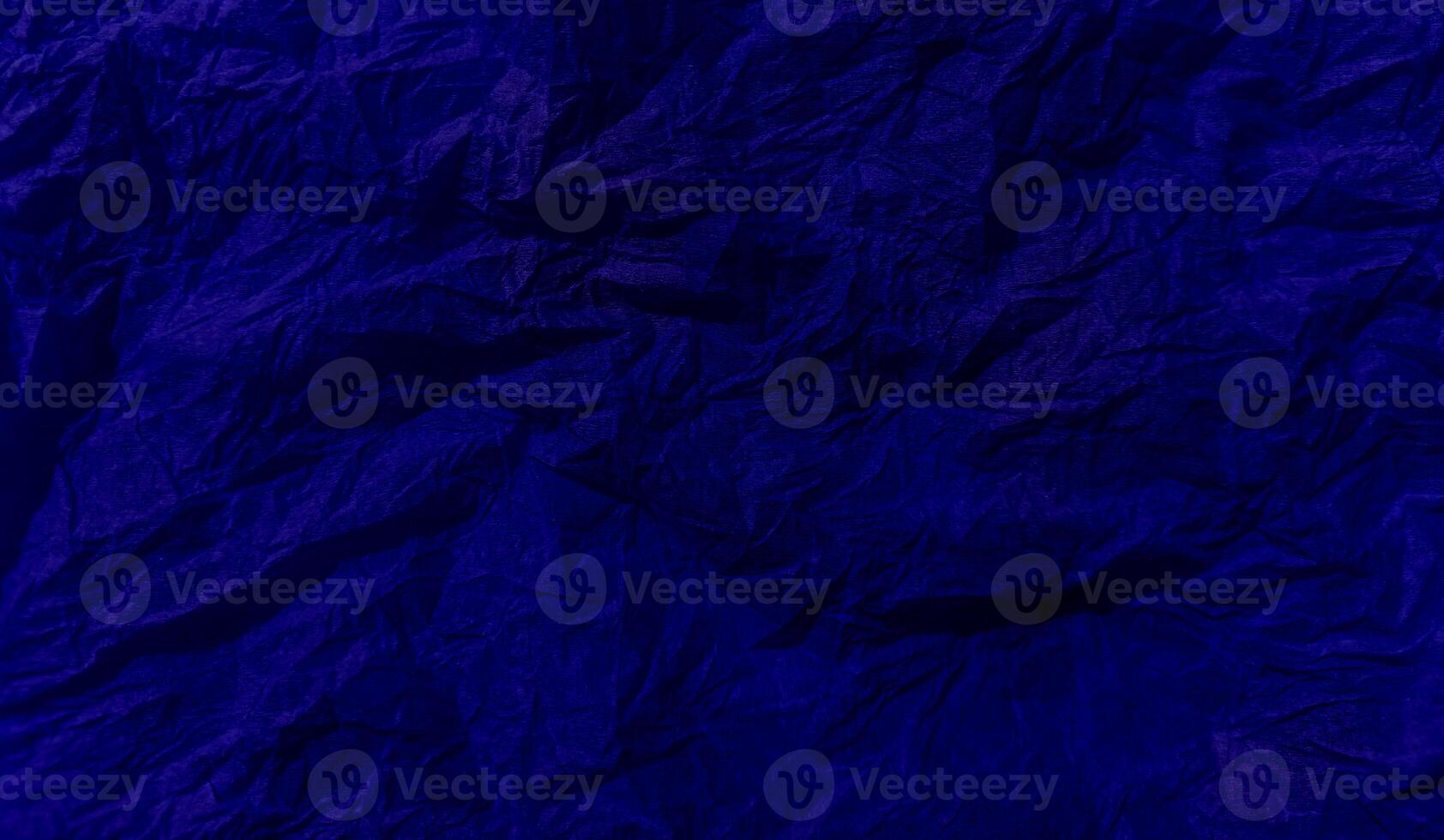 Abstract wrinkled or Free photo crumpled blue or purple paperboard or empty canvas or paper surface or fabric stain background.