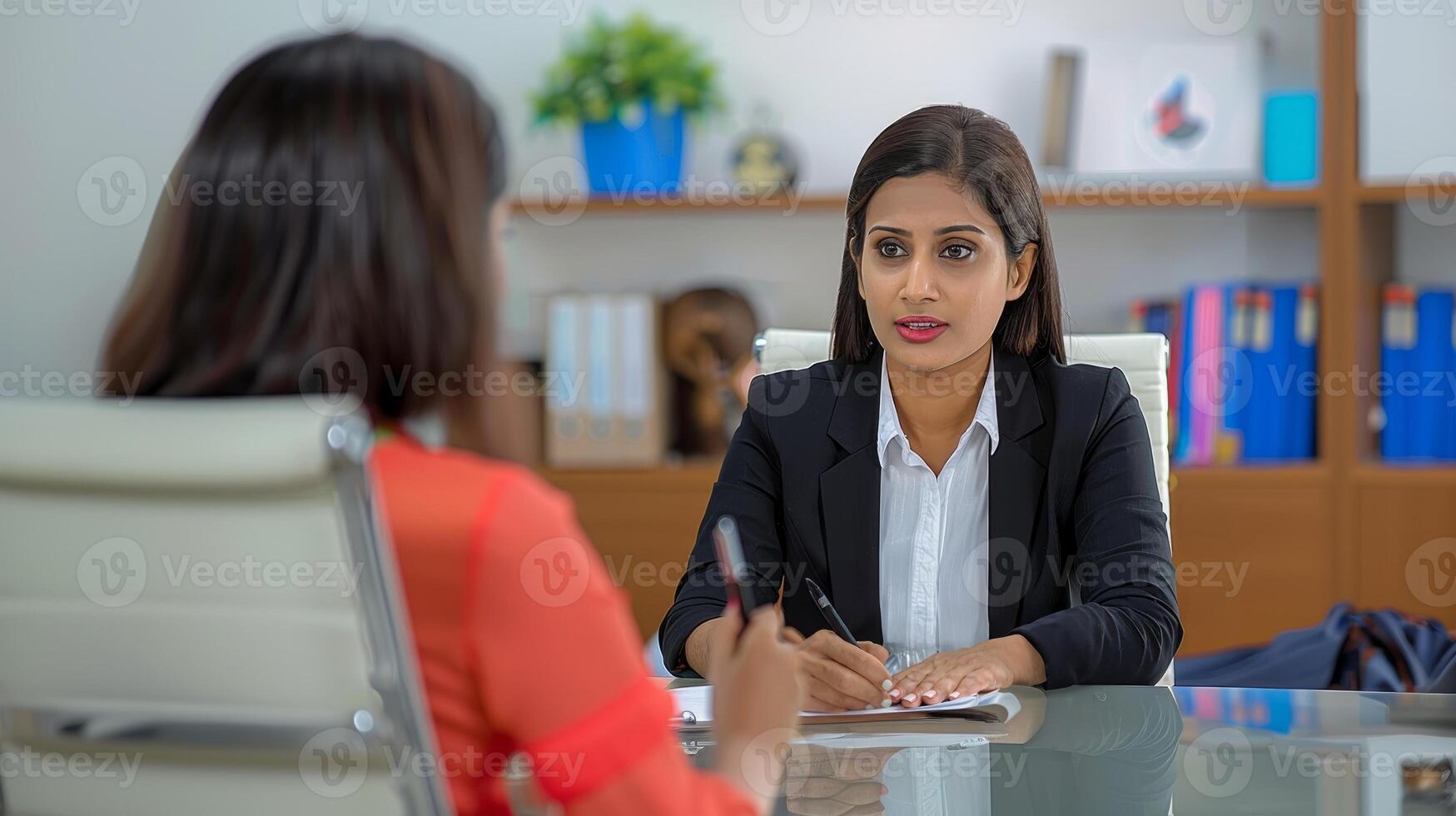 A Indian woman manager and a female candidate meeting at work photo
