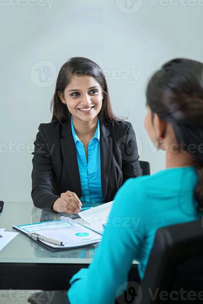 A Indian woman manager and a female candidate meeting at work photo