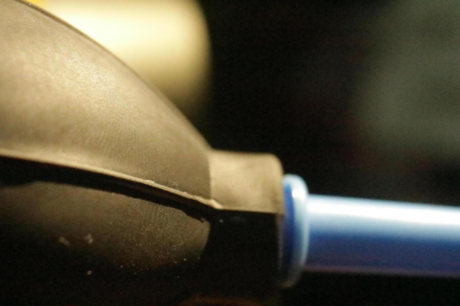 Close-up of black rubber bulb with blue nozzle photo