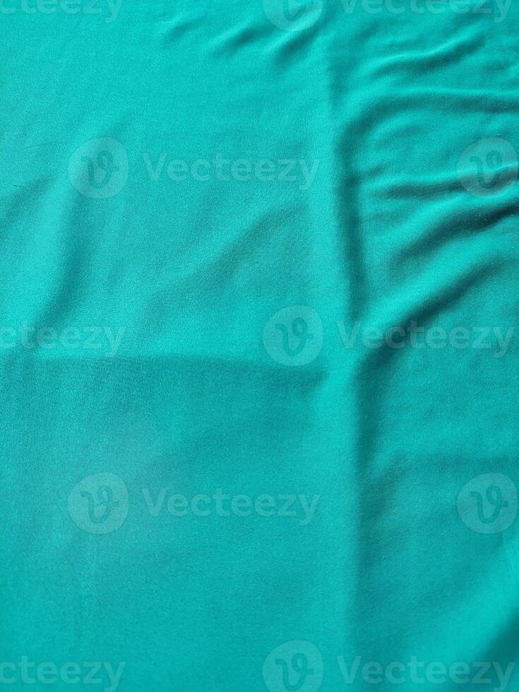 Cyan colored fabric texture and background photo