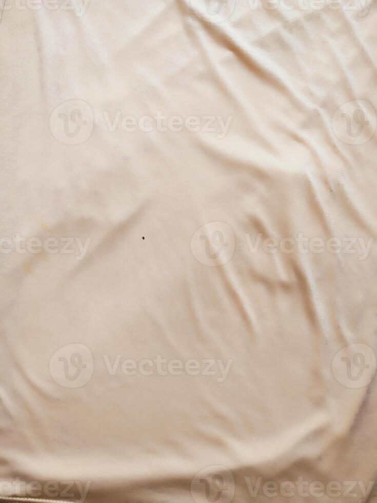 texture and background of wrinkled cream fabric photo