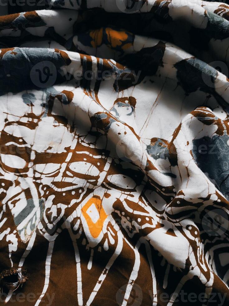 The fabric is patterned with a dense arrangement of blooming floral motifs in medium tones photo