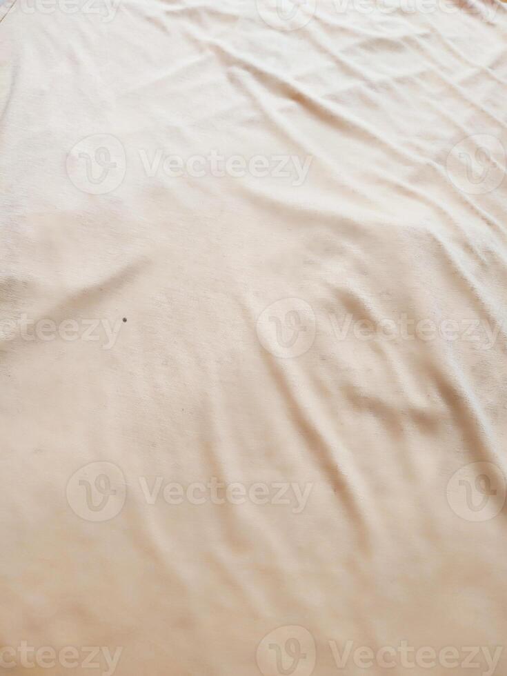 texture and background of wrinkled cream fabric photo