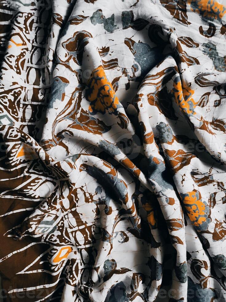 The fabric is patterned with a dense arrangement of blooming floral motifs in medium tones photo