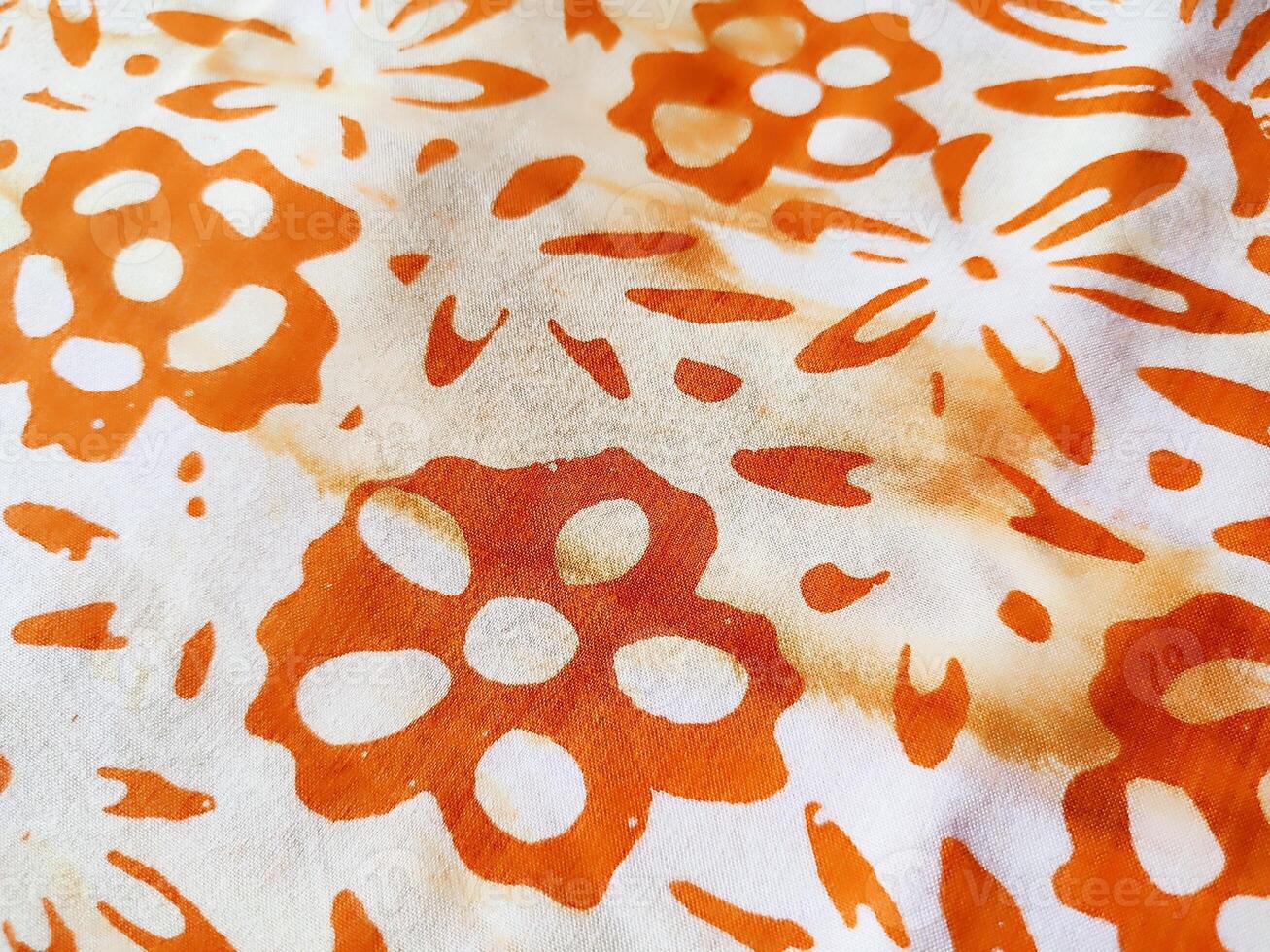 The fabric is patterned with a dense arrangement of blooming floral motifs in medium tones photo