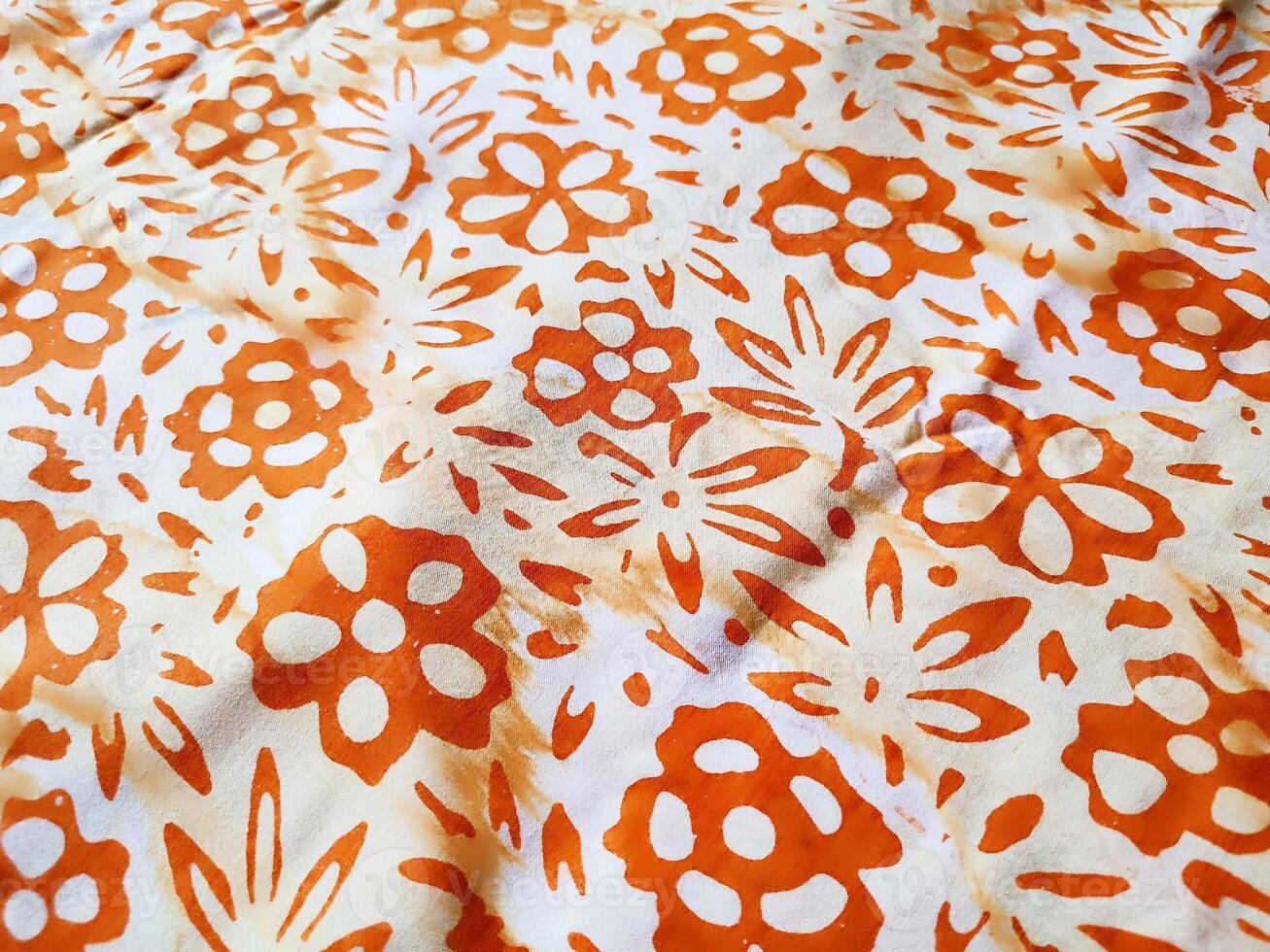 The fabric is patterned with a dense arrangement of blooming floral motifs in medium tones photo
