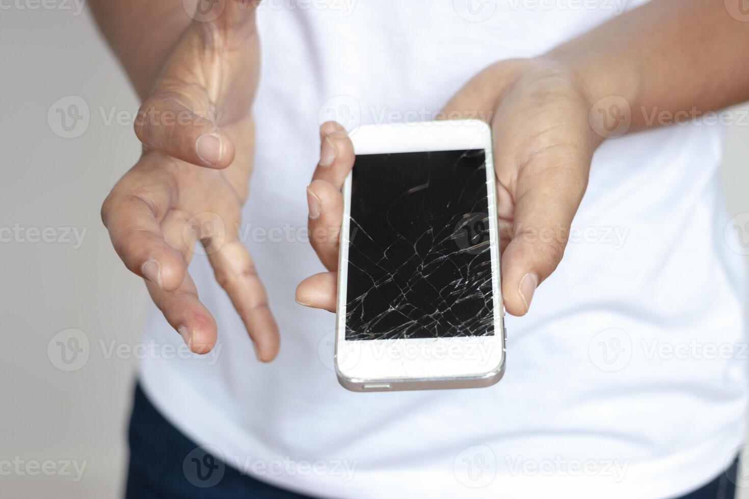 Woman holding phone That dropped the screen, cracked in the hand ,Very sad. photo
