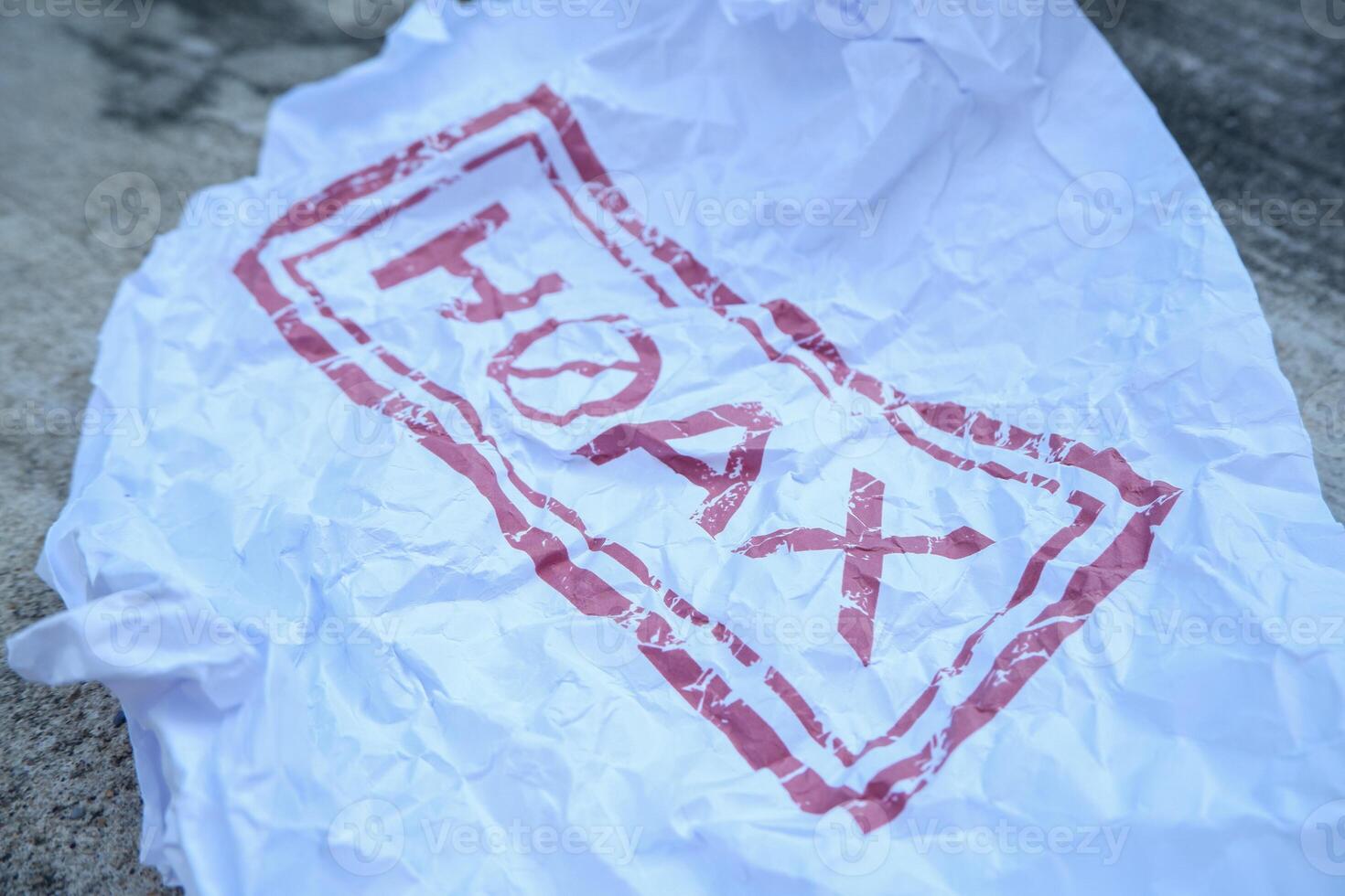 crumpled paper with hoax writing in red. illustration concept of stop giving false or fake news photo