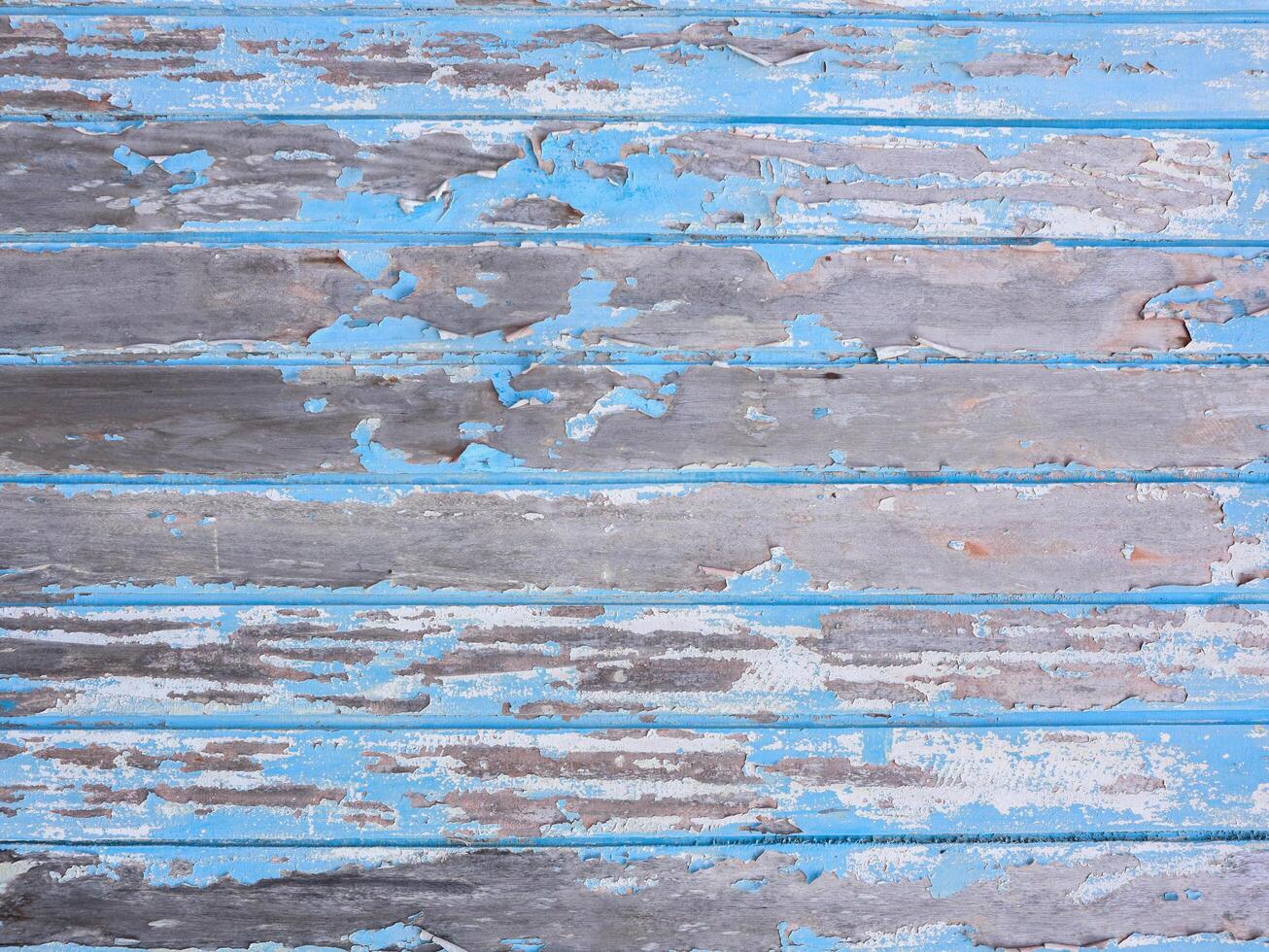 background of old wooden blue planks whose paint is faded and peeling photo