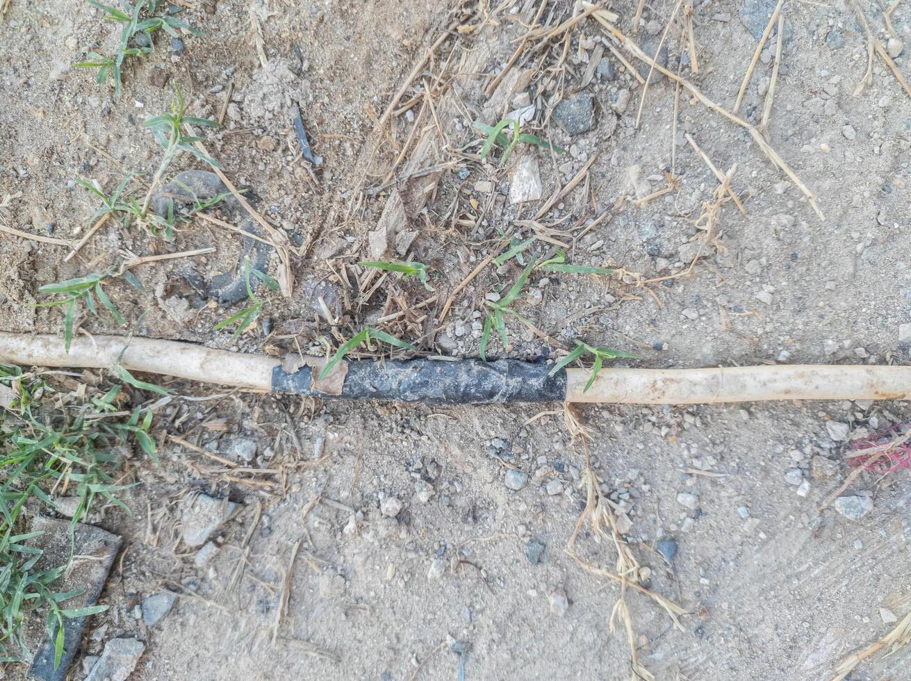 cables connected using black insulation run across the ground. electrical hazard work safety concept photo