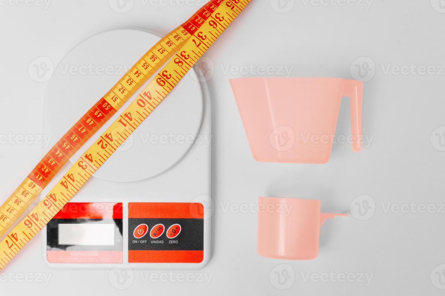 zenith shot of kitchen scale, a meter and scoops over white background. photo