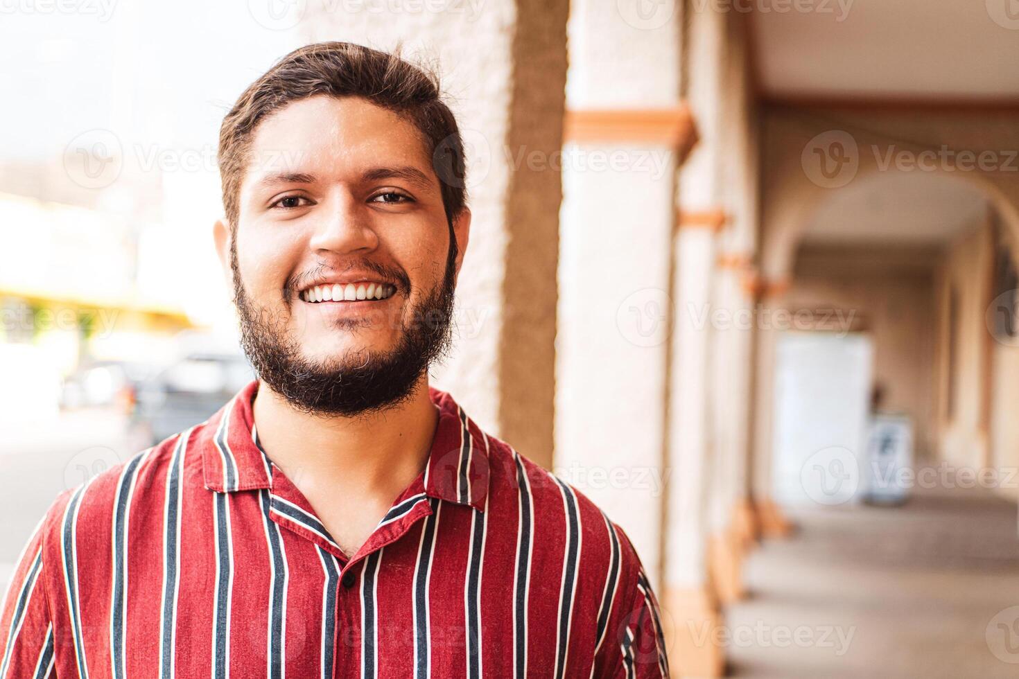 closeup portrait of a young latin american man smiling looking at camera photo