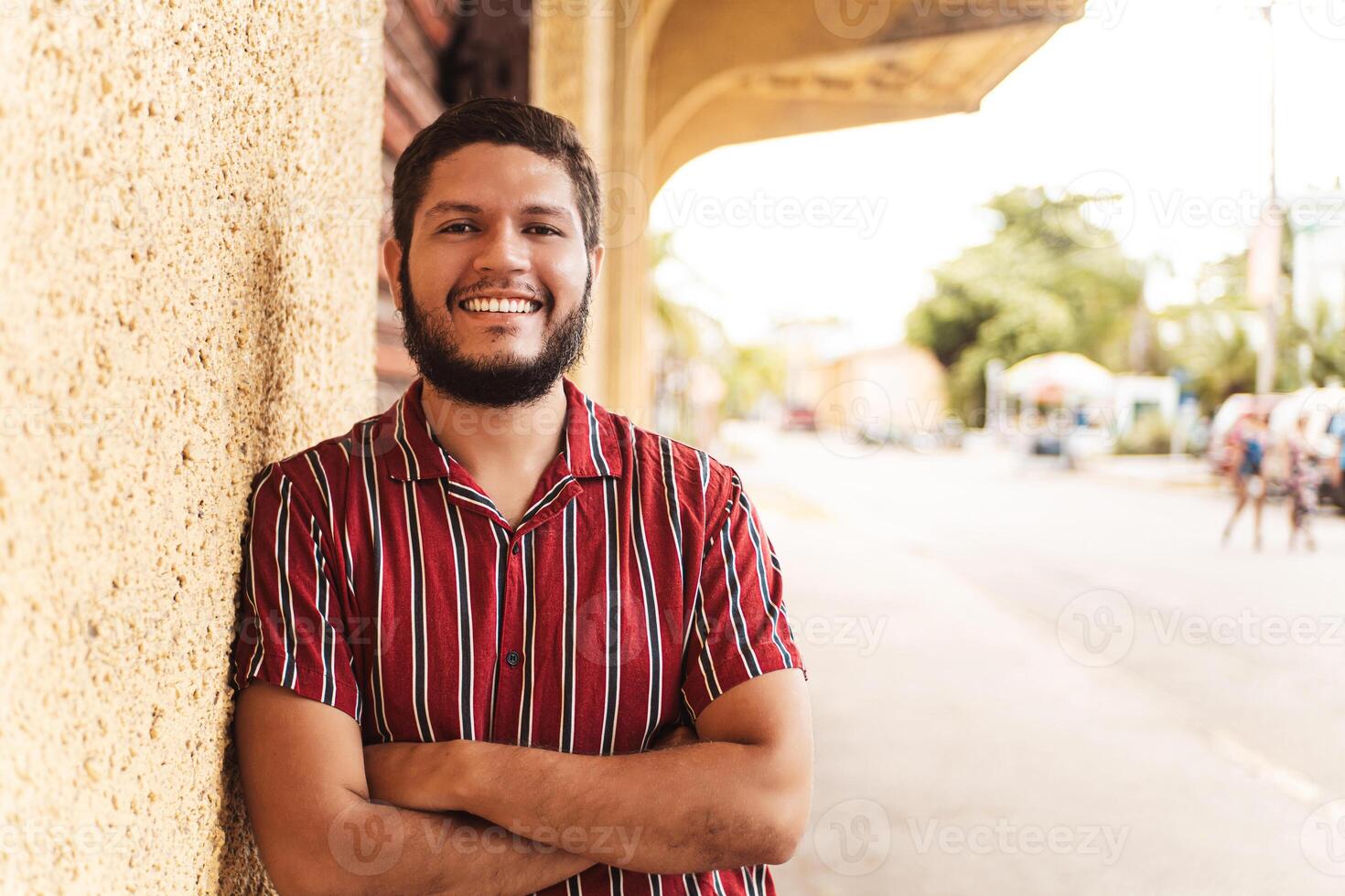 portrait of a young latin american man smiling looking at camera. photo