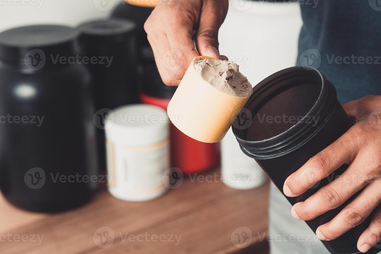 Hands holding scoop of whey protein and shaker with copy space healthy life. photo