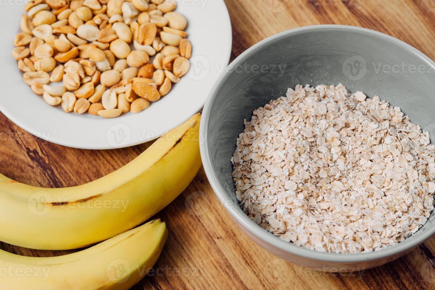 Ingredient of a milkshake banana, peanut and oatmeal healthy breakfast concept. photo