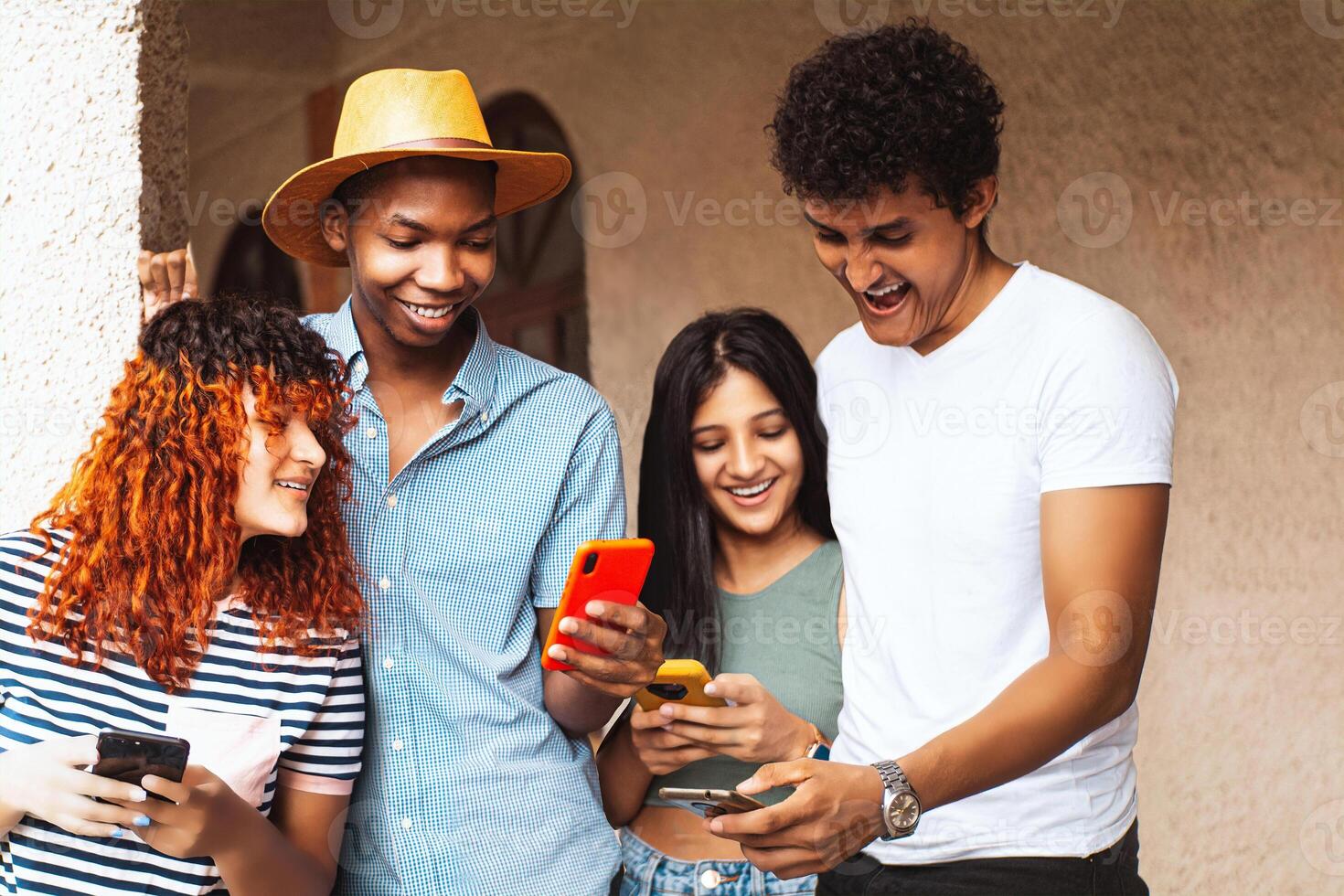 Group of friends using mobile phone, technology and friendship concept. photo