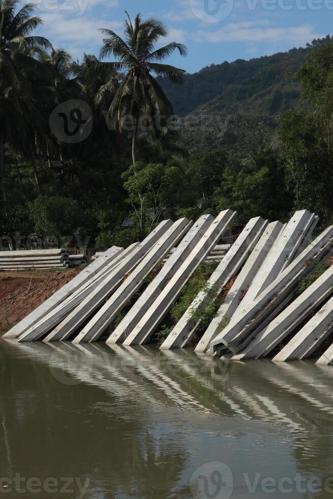 A group of concrete blocks are on the water photo