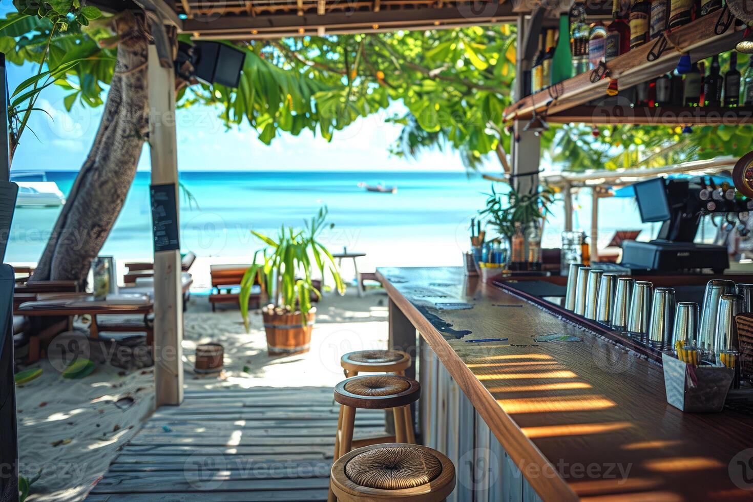 Tropical beach bar with ocean view on a sunny day. Empty bar counter and stools under lush greenery, overlooking the clear blue sea. Perfect spot for relaxing and enjoying the summer vibes. photo