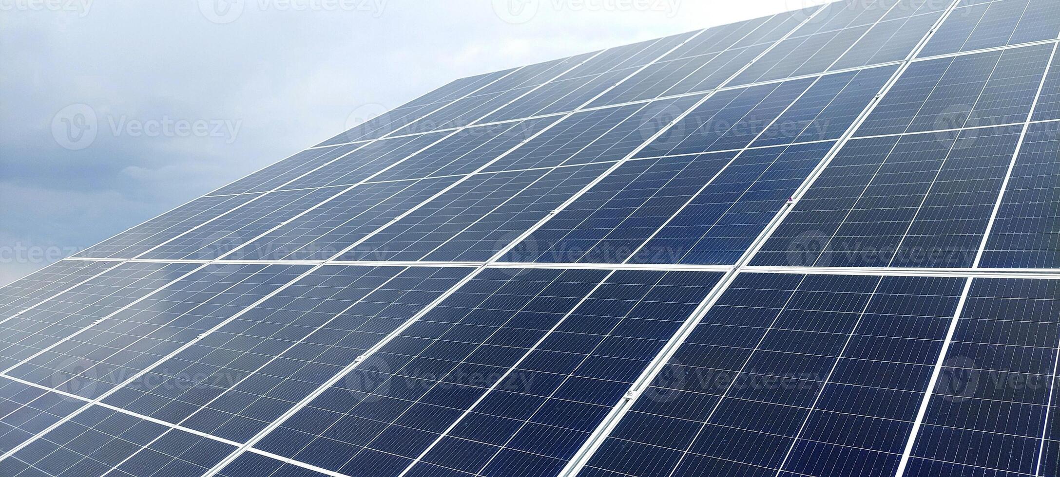 Solar panels on the background of a natural landscape. The construction of the solar battery farm photo