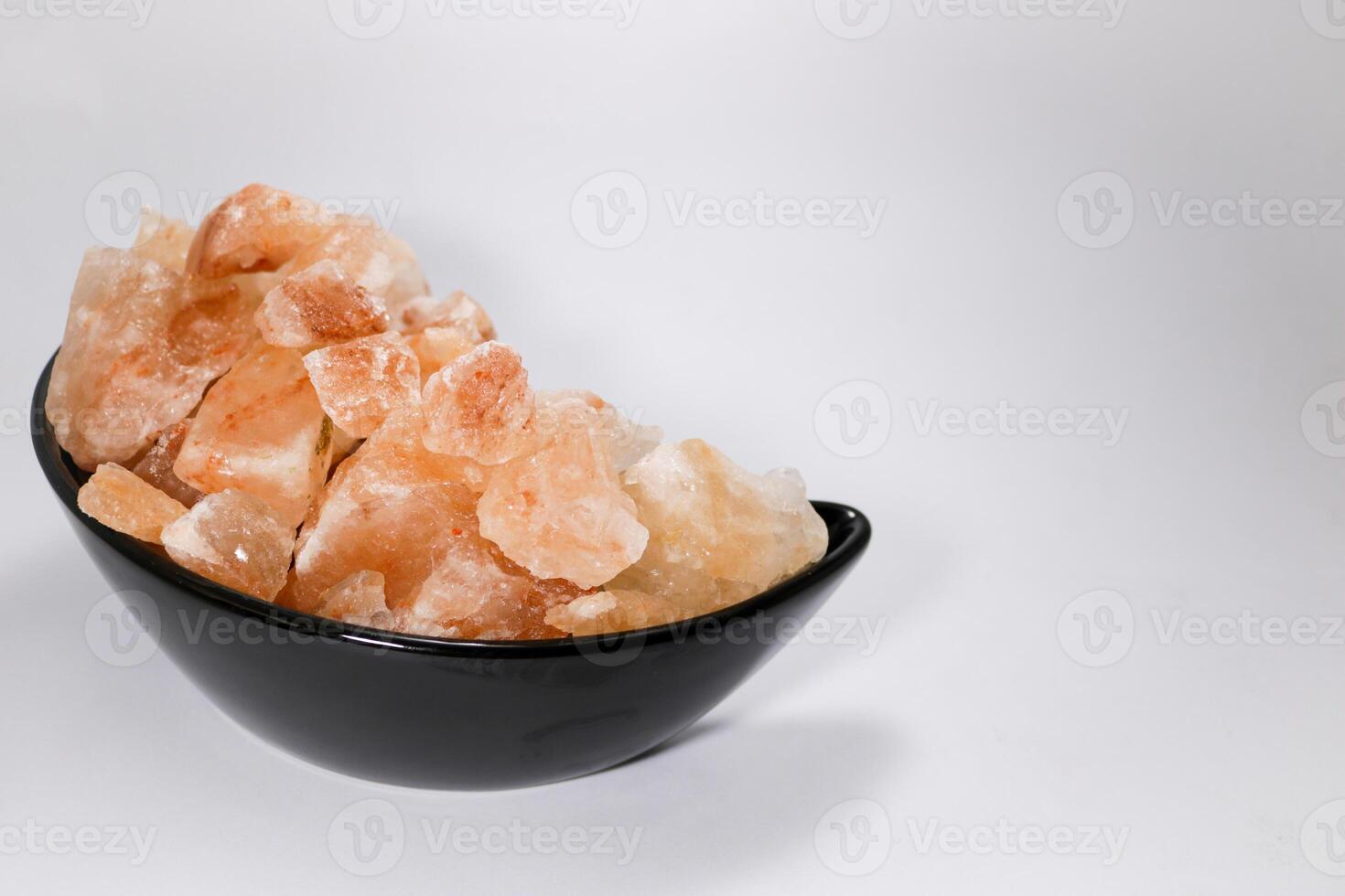Pink Himalayan Salt Rocks on isolated black background photo