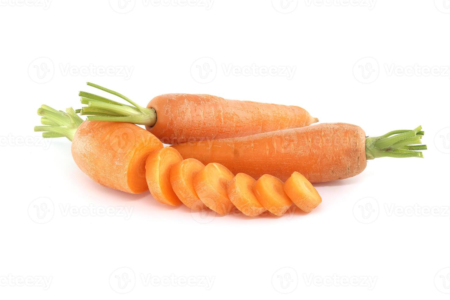 Whole carrot and its sliced pieces isolated against a white background photo