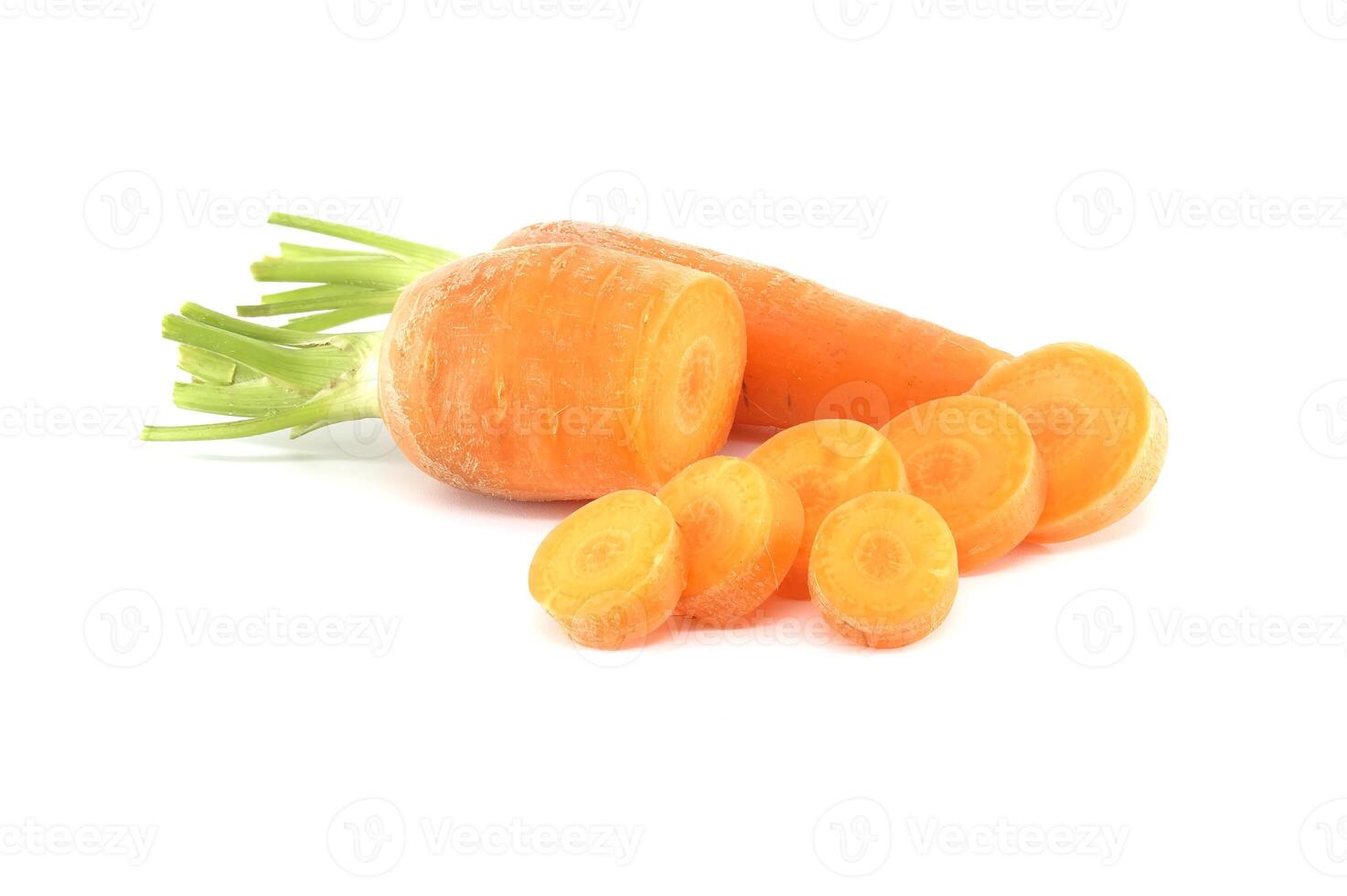 Whole carrot and its sliced pieces isolated against a white background photo