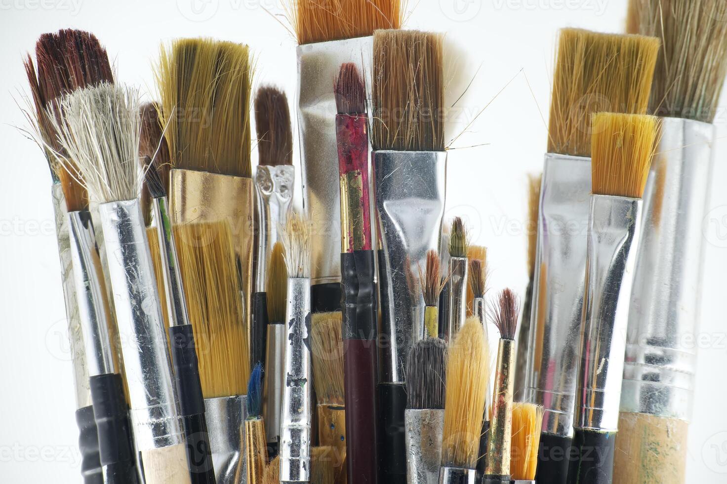 Assortment of various types and sizes of paintbrushes photo