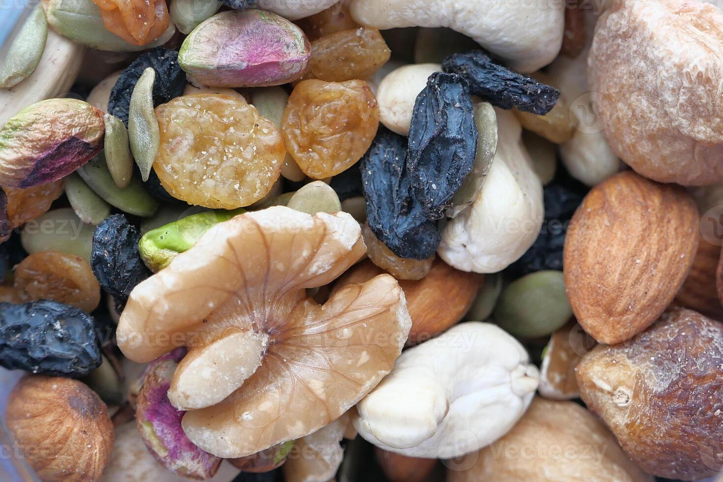 Photograph of a highresolution macro of an assorted mix of nuts and dried fruits photo