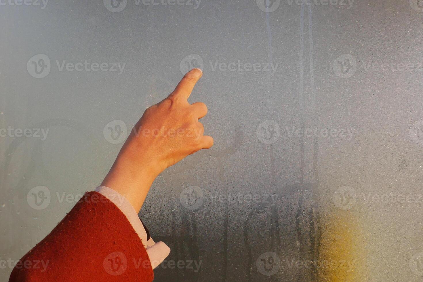 A Pointing Hand Through Foggy Glass suggests mystery and communication in a blurred scene photo