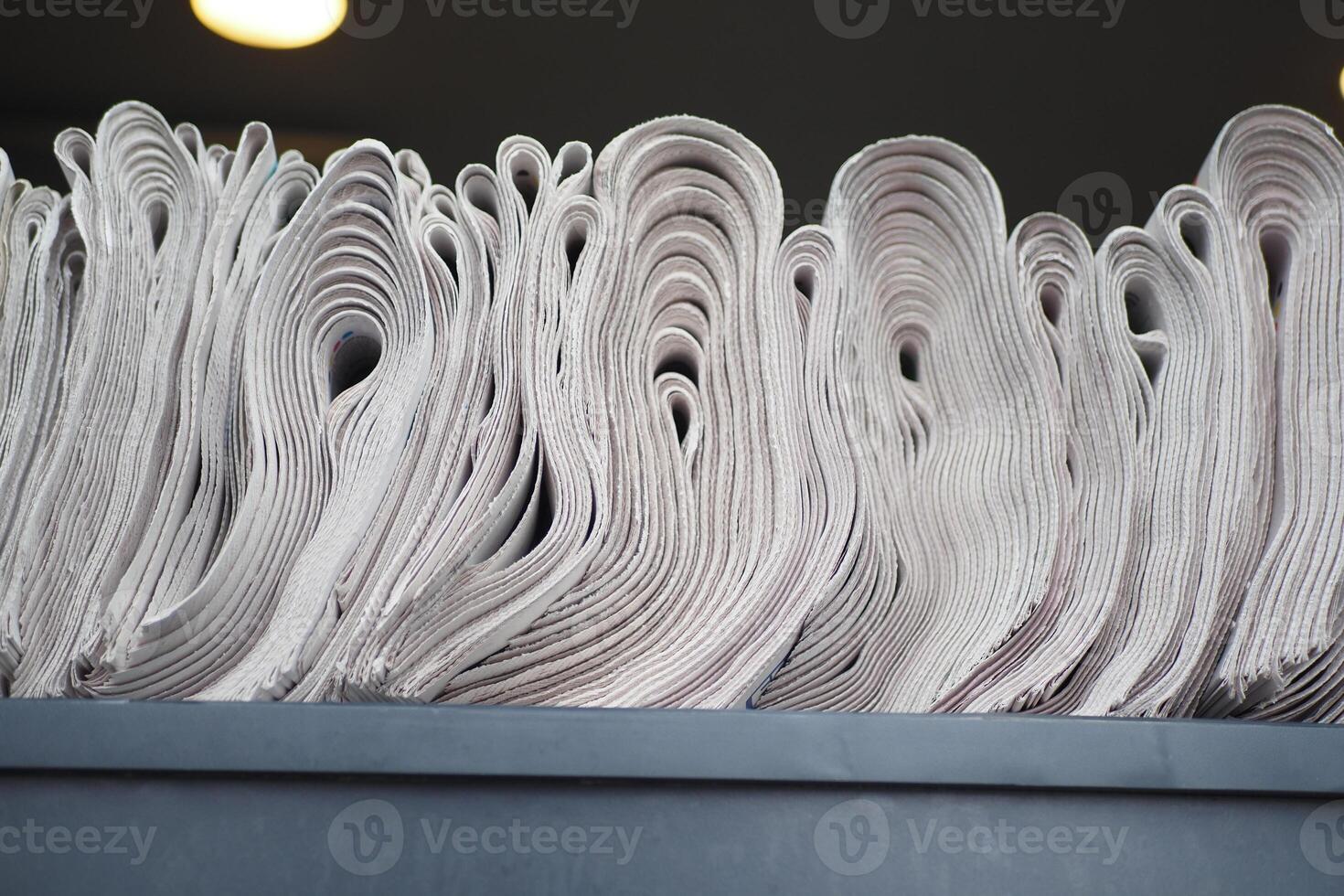 Pile of newspapers stacks on table . photo