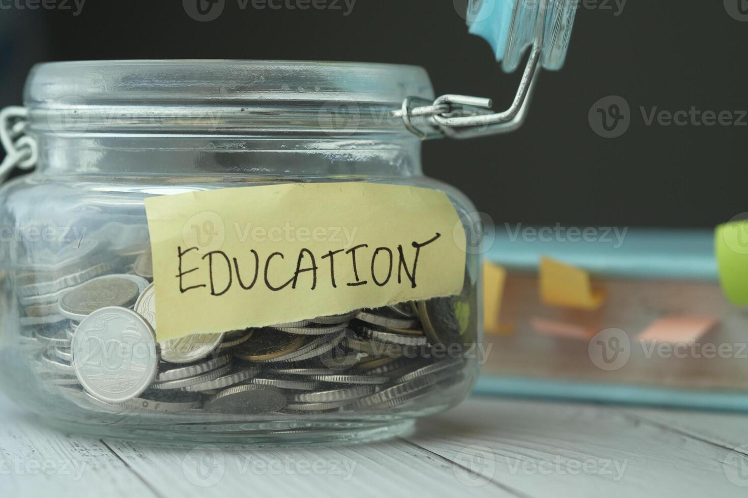 Coins in glass jar with education label. photo