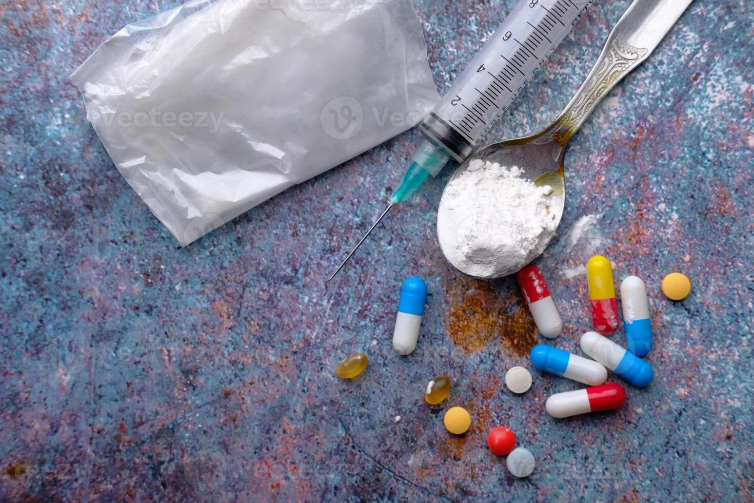 high angle view of Drug, syringe with cooked heroine on black background photo
